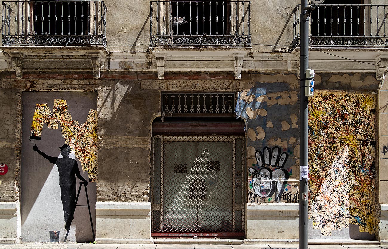 Artist Pejac has created a work of a man painting in Malaga's Soho district.